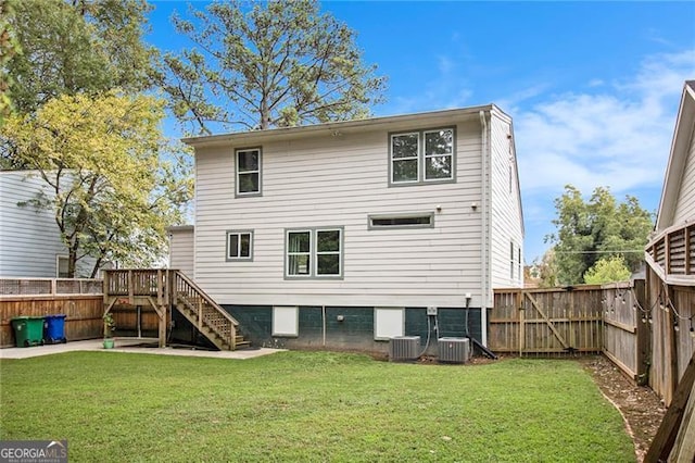 back of property featuring central AC and a yard