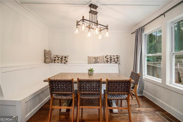 dining room featuring crown molding, breakfast area, and dark hardwood / wood-style flooring