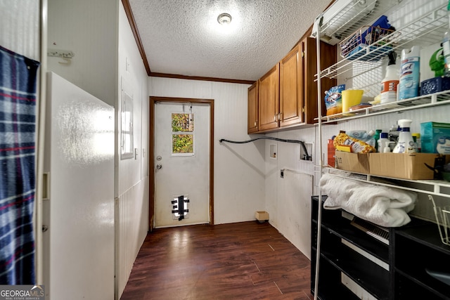 clothes washing area featuring washer hookup, crown molding, dark hardwood / wood-style floors, and a textured ceiling