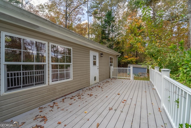 wooden deck with a storage shed