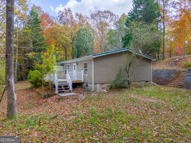 rear view of house featuring a deck