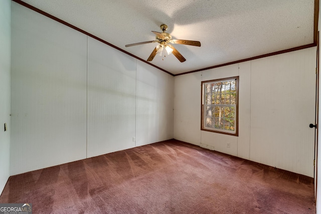 unfurnished room featuring ceiling fan, ornamental molding, carpet floors, and a textured ceiling