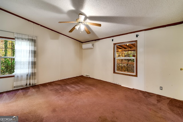 carpeted spare room featuring a wealth of natural light, ornamental molding, a wall unit AC, and a textured ceiling