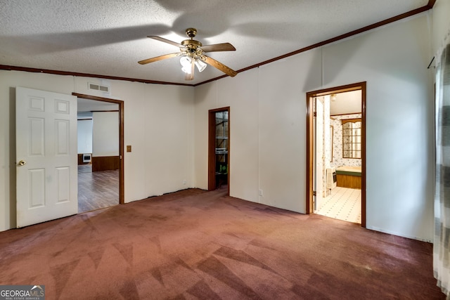 unfurnished bedroom featuring crown molding, ceiling fan, carpet flooring, and a textured ceiling