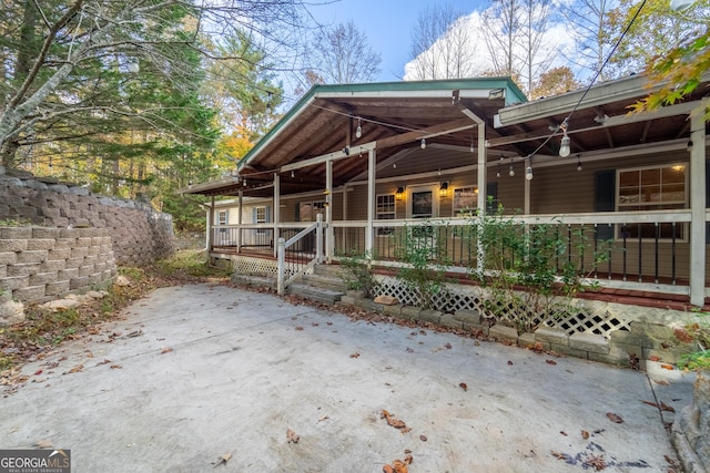 view of side of property featuring a porch