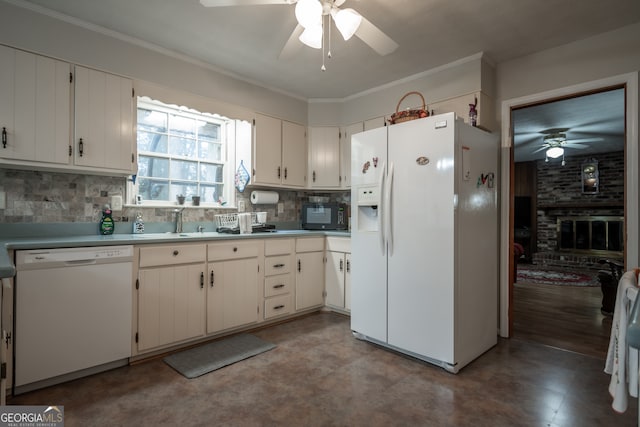 kitchen featuring ornamental molding, sink, white cabinets, white appliances, and tasteful backsplash