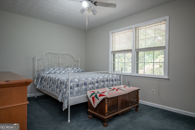 bedroom featuring dark colored carpet and ceiling fan