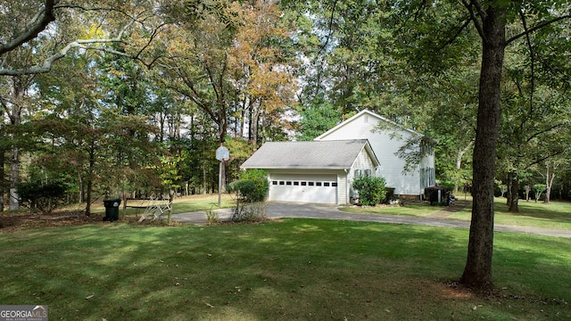 view of side of home with a lawn and a garage