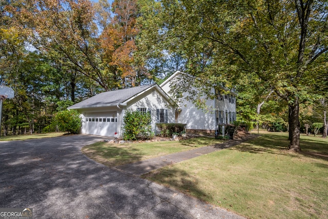 view of front of property with a front yard and a garage