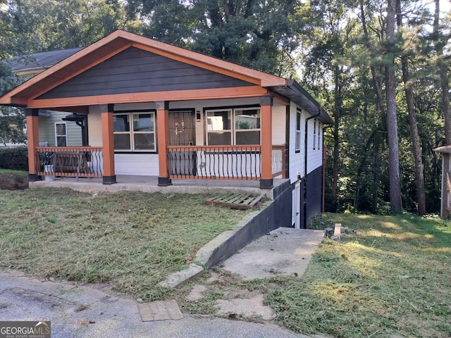 view of front of property with covered porch and a front yard