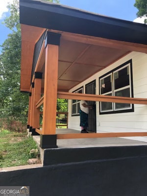 view of side of property with a porch