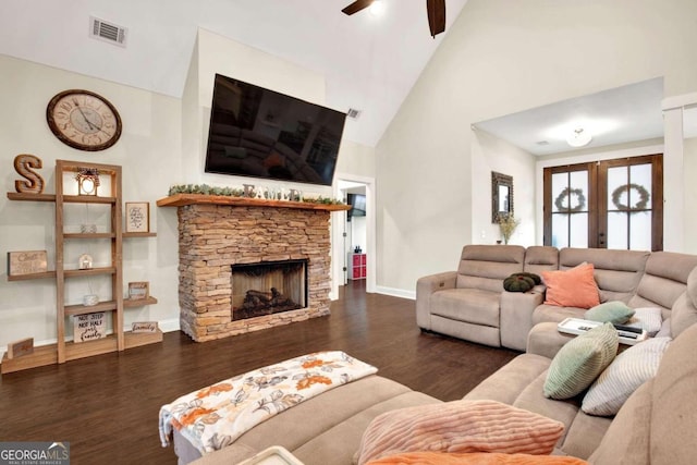 living room featuring french doors, a stone fireplace, dark hardwood / wood-style flooring, high vaulted ceiling, and ceiling fan