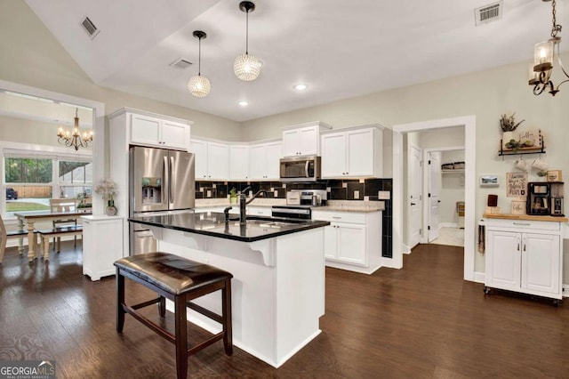 kitchen with appliances with stainless steel finishes, sink, and white cabinets