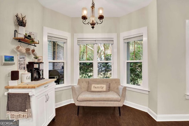 living area with a notable chandelier and dark wood-type flooring