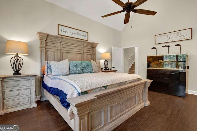 bedroom with dark hardwood / wood-style flooring, high vaulted ceiling, and ceiling fan