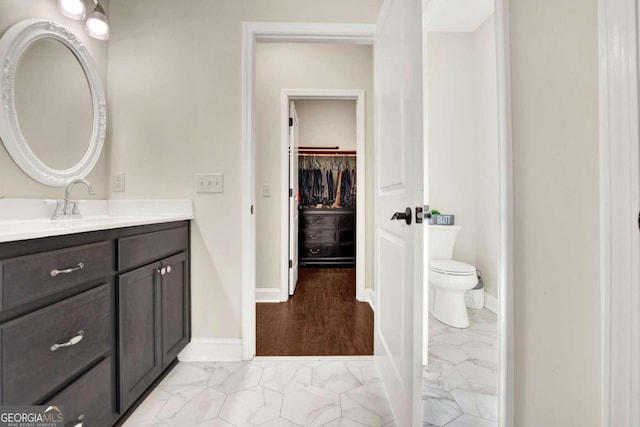 bathroom with vanity, hardwood / wood-style floors, and toilet