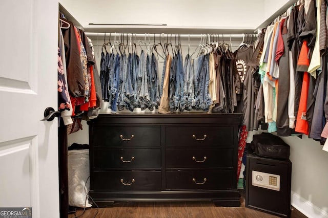 spacious closet with dark hardwood / wood-style floors