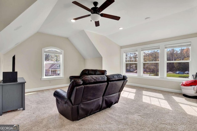 living room featuring light carpet, ceiling fan, and vaulted ceiling