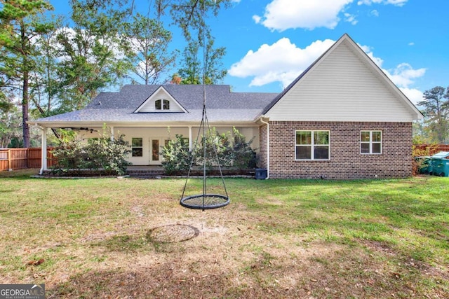 back of property featuring a lawn