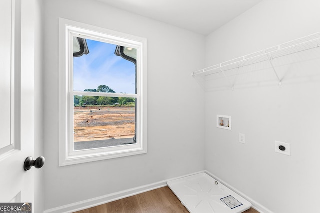 laundry area with hardwood / wood-style flooring, hookup for an electric dryer, and washer hookup