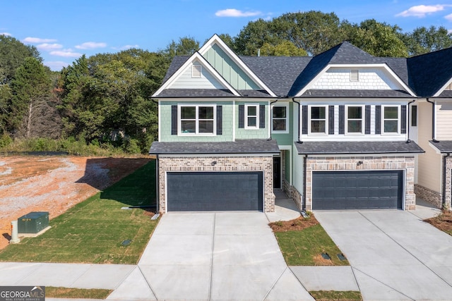 view of front of home featuring a garage and a front lawn