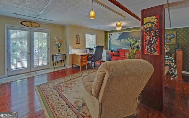 living room with french doors, dark hardwood / wood-style floors, a textured ceiling, and plenty of natural light