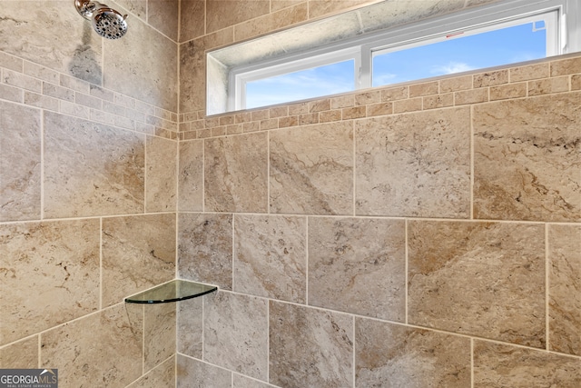 interior details featuring a tile shower