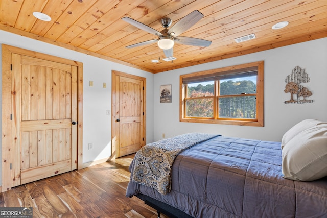 bedroom with ceiling fan, hardwood / wood-style floors, and wood ceiling