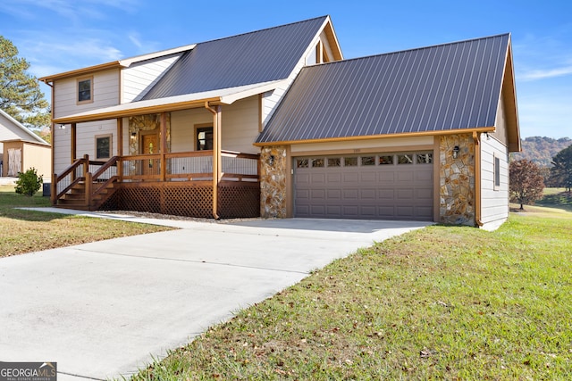 view of front facade featuring a front lawn, covered porch, and a garage