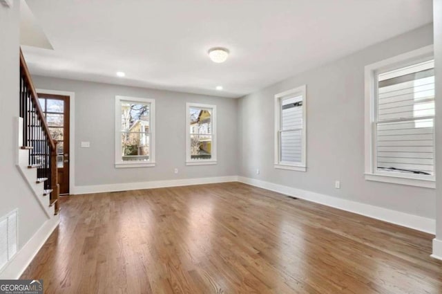 empty room with dark hardwood / wood-style flooring