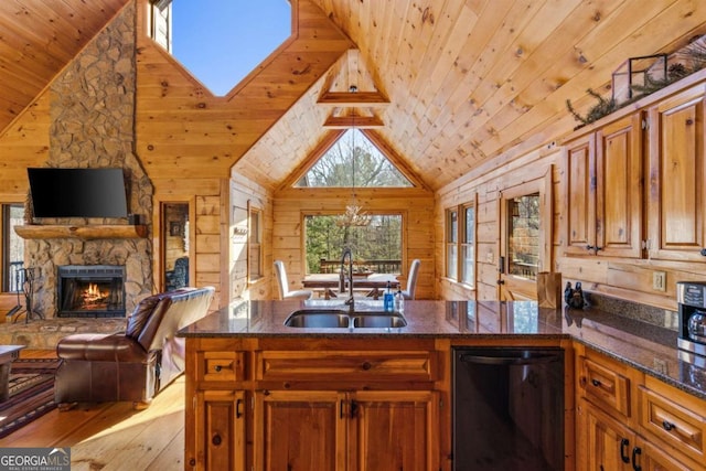 kitchen featuring light hardwood / wood-style flooring, wood walls, dishwasher, and sink