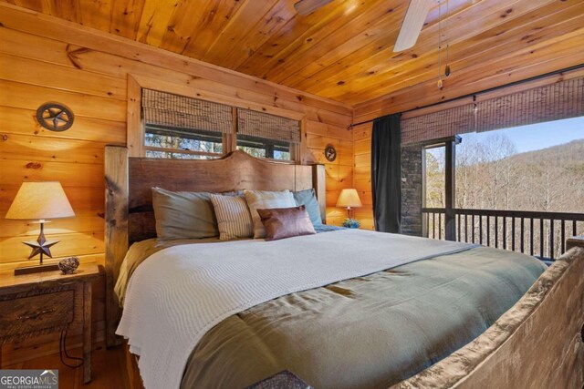 bedroom featuring wood walls, wooden ceiling, and multiple windows