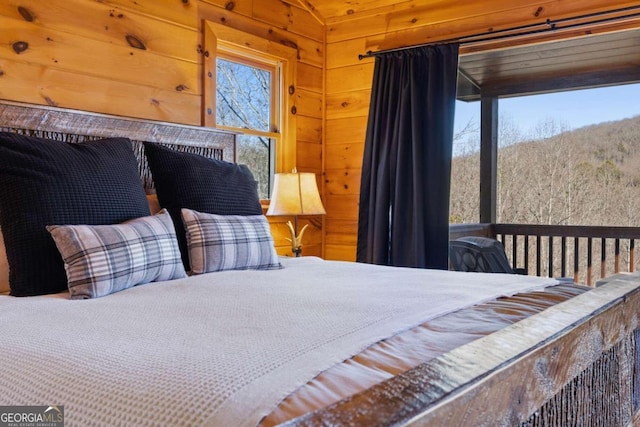 bedroom featuring wood walls