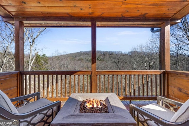 wooden terrace with a fire pit