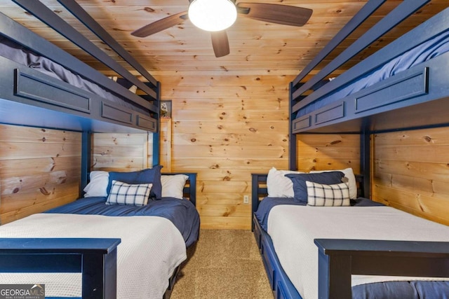 bedroom featuring light carpet, wood ceiling, wooden walls, and ceiling fan