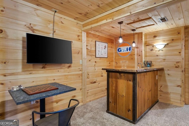 bar with wooden walls, light carpet, decorative light fixtures, and wood ceiling