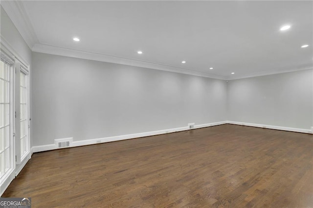 spare room with dark hardwood / wood-style flooring and crown molding