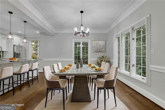 dining area featuring dark hardwood / wood-style floors, crown molding, a notable chandelier, and a healthy amount of sunlight