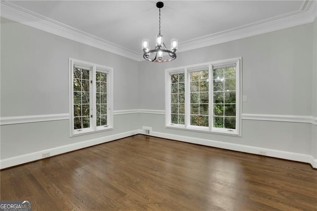 unfurnished dining area with dark hardwood / wood-style floors, ornamental molding, and a notable chandelier