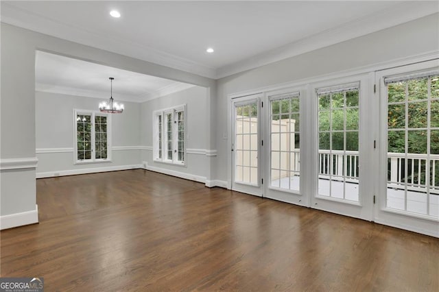 interior space with dark wood-type flooring, an inviting chandelier, and ornamental molding