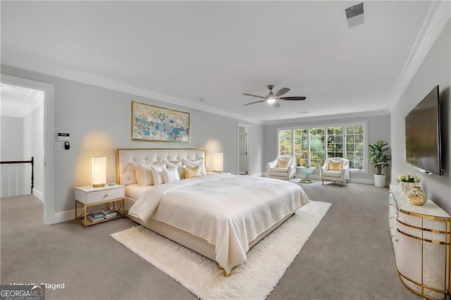 carpeted bedroom featuring ceiling fan and crown molding