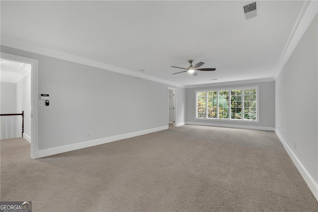 empty room with ceiling fan, light colored carpet, and ornamental molding