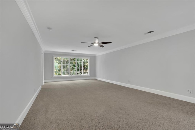 carpeted empty room with ceiling fan and crown molding