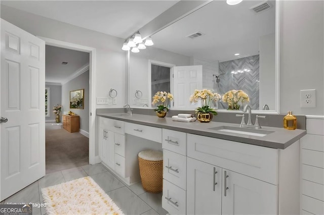 bathroom with a shower, ornamental molding, and vanity