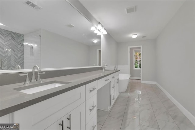 bathroom with a washtub and vanity