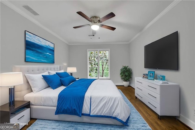 bedroom featuring ceiling fan, dark hardwood / wood-style flooring, and ornamental molding