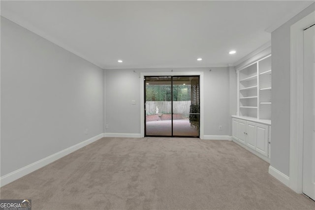 unfurnished room featuring built in features and light carpet