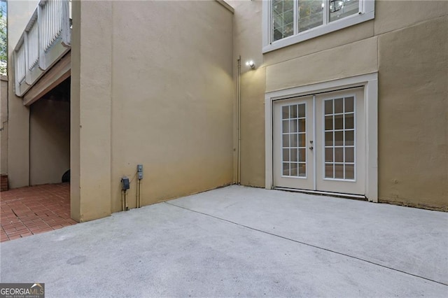 property entrance featuring a patio area and french doors