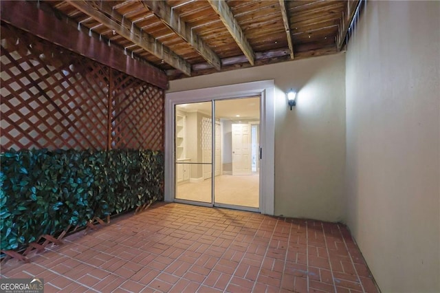 unfurnished sunroom with beam ceiling and wood ceiling