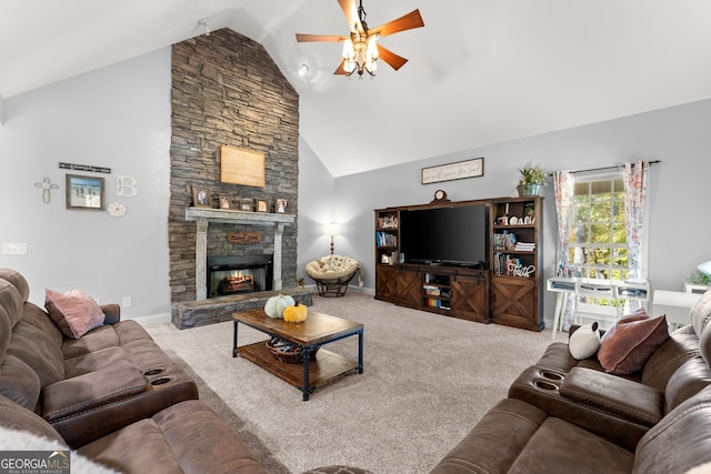 carpeted living room featuring a stone fireplace, high vaulted ceiling, and ceiling fan